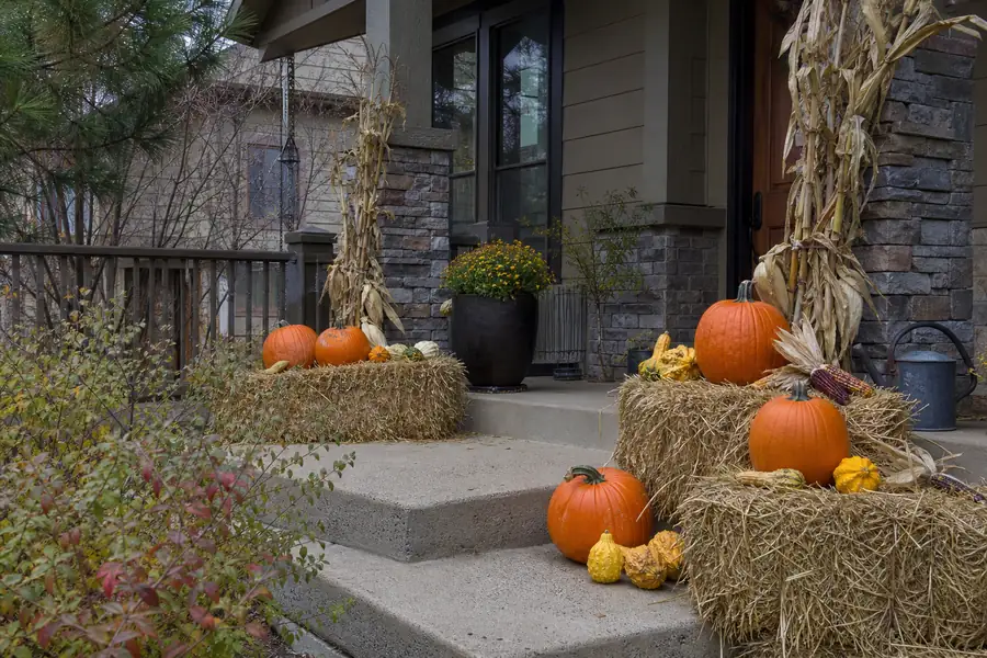 Decorated front porch in a Boulder County neighborhood styled with pumpkins and hay bales